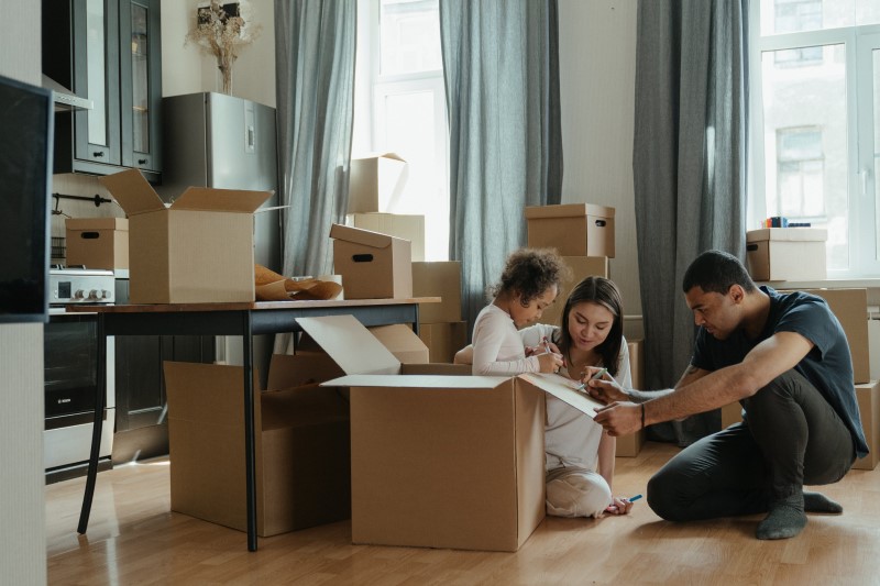 family unpacking boxes in their home